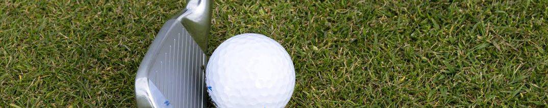 Silver Wedge Golf Club Beside Ball