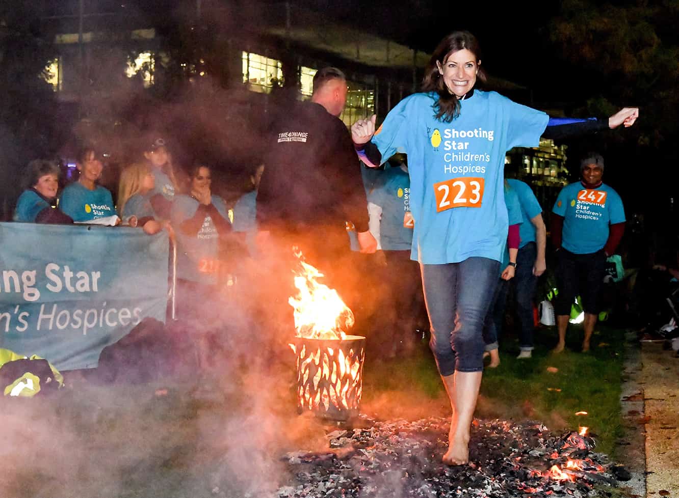 A woman taking part in a fire walk