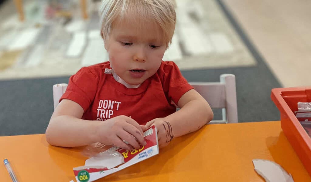 Child playing with some stickers