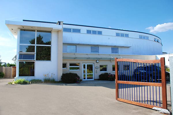 The front of Shooting Star House, a large white building with gates.