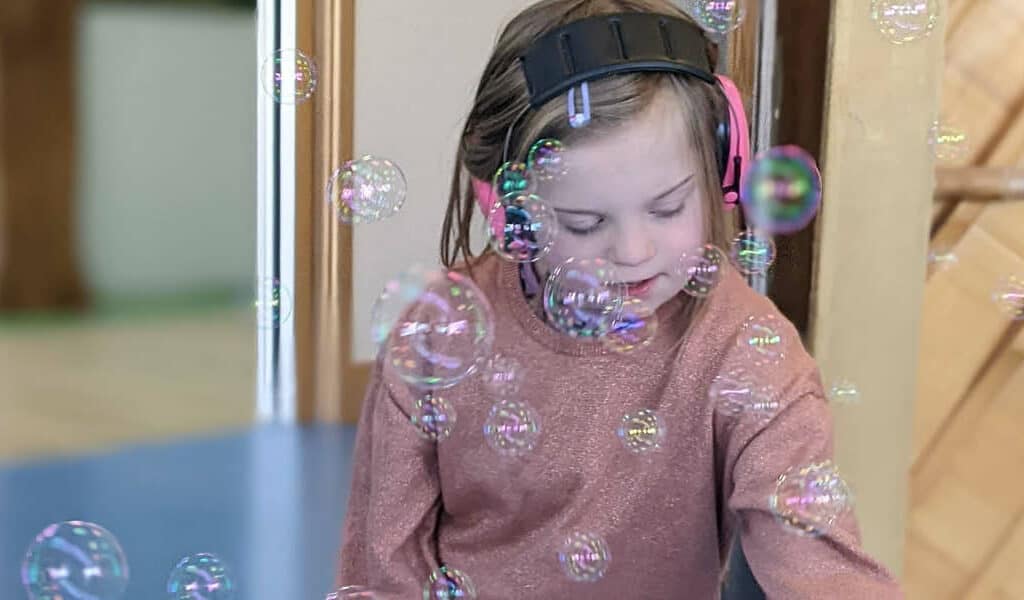 Sophie playing with bubbles at a drop in session