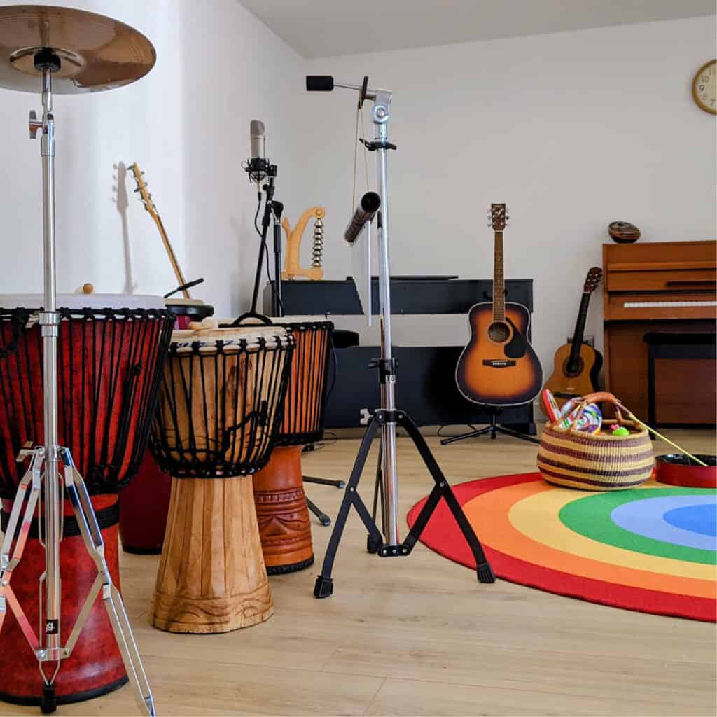 Music therapy studio with instruments including free standing drums, guitar and piano