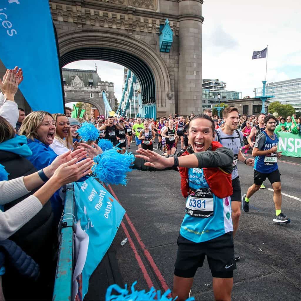 London marathon runner celebrates at the cheer point on Tower Bridge