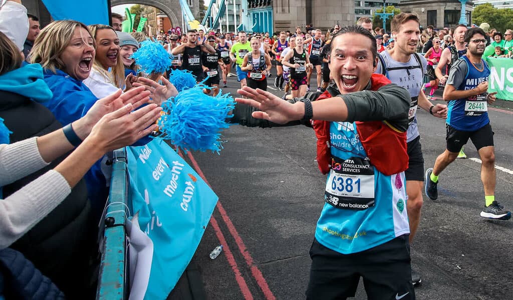 London marathon runner celebrates at the cheer point on Tower Bridge