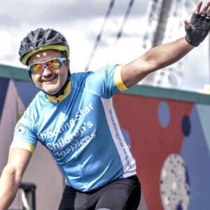 A cyclist wearing his blue and yellow cycling jersey