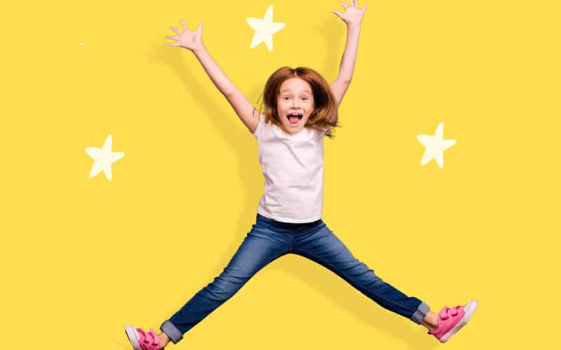 Child doing a star jump