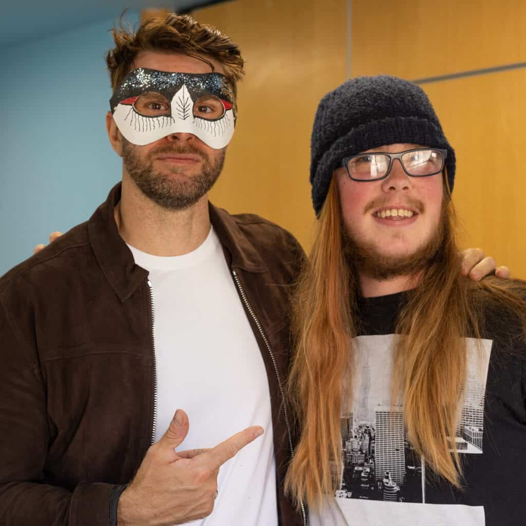 Joel Dommett wearing a mask meets a fan at our