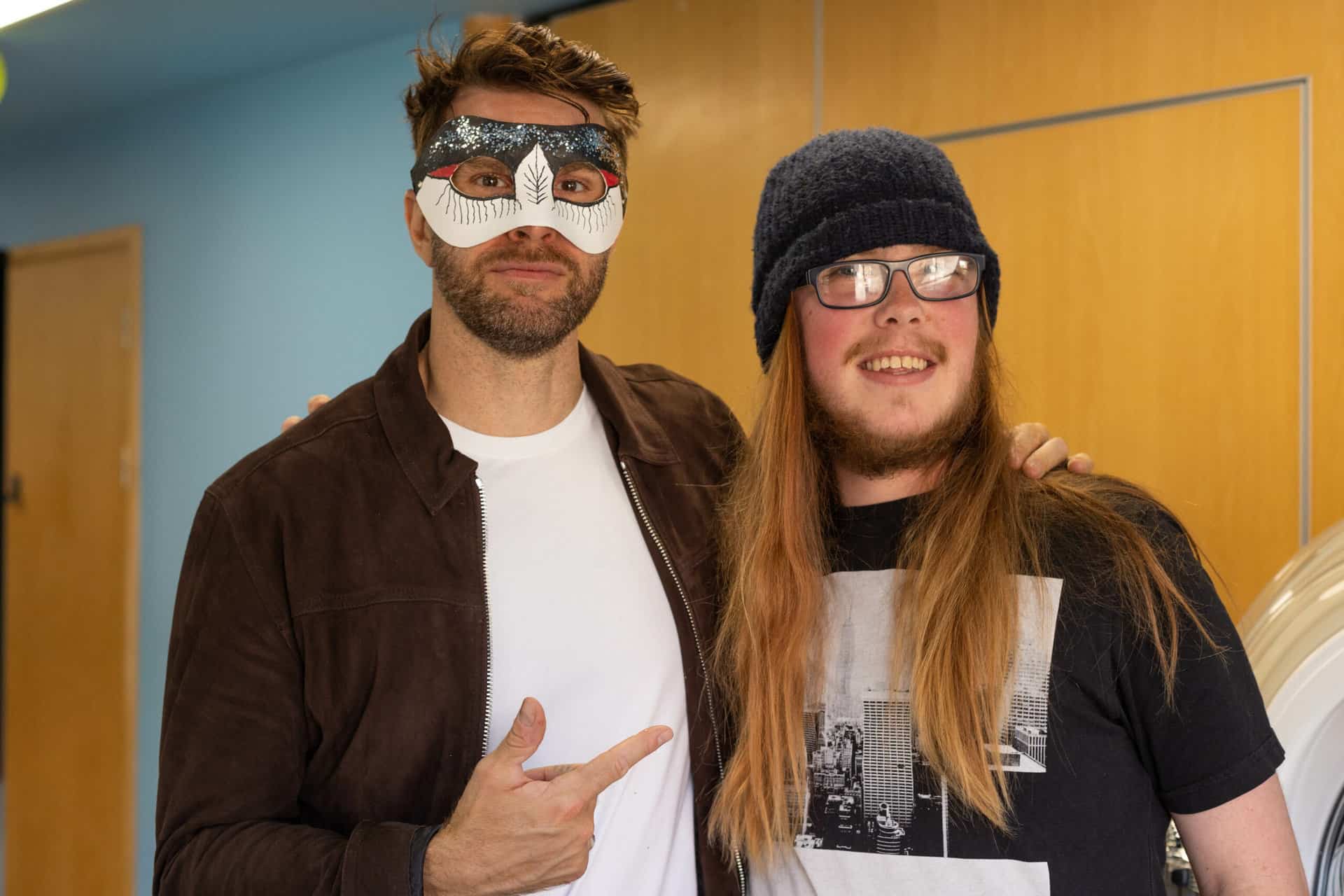 Joel Dommett wearing a mask meets a fan at our