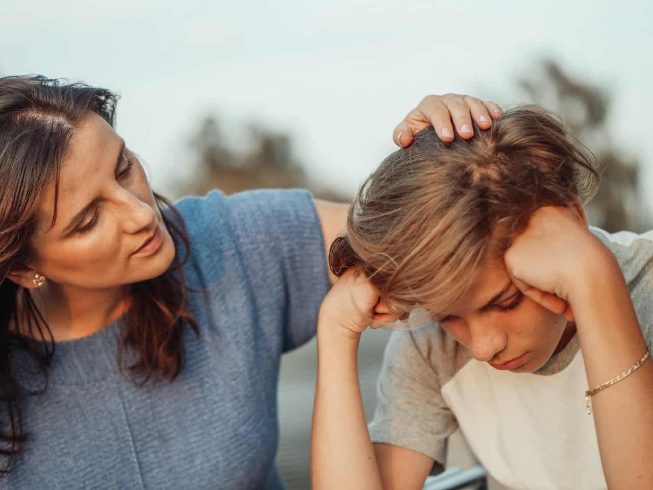 Image of parent comforting a child