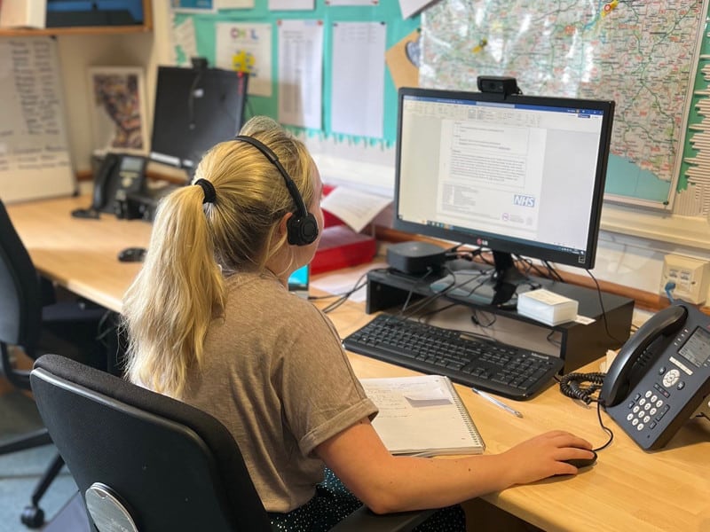 A community nurse working at a computer