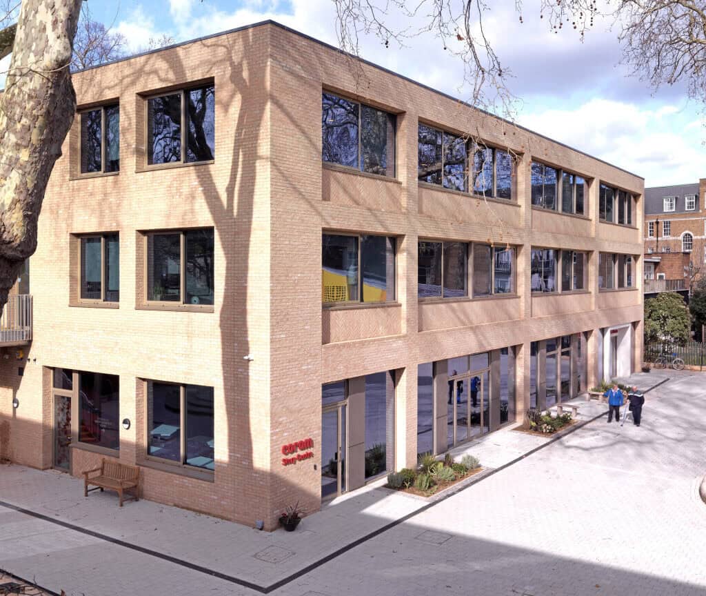 The Coram Queen Elizabeth II confernce Centre, a three story brick building in an open leafy part of London