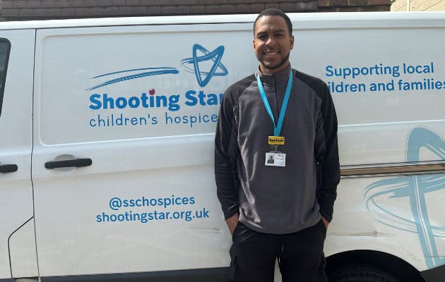A man standing in front of A Shooting Star Branded retail van.