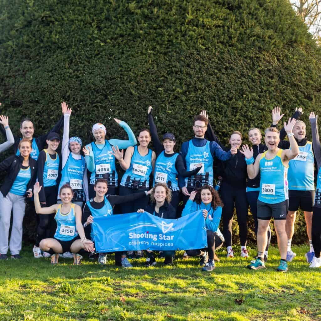 Team at running event holding a banner