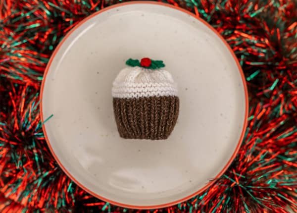 Knitted Christmas pudding on plate