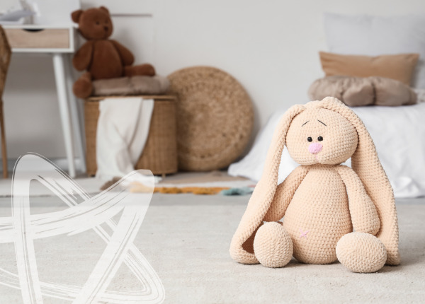 A toy bunny on a bedroom floor