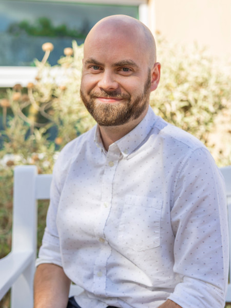 A smiling young man with a beard.