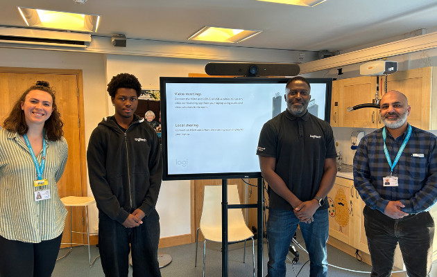 People in front of a large TV screen